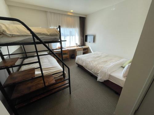 Ένα ή περισσότερα κρεβάτια σε δωμάτιο στο Hotel Crown Hills Ueno Premier