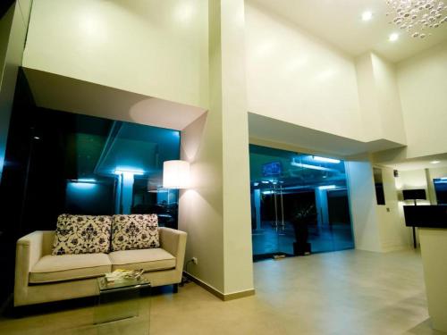 a living room with a couch in a building at Pannapat Place in Bangkok