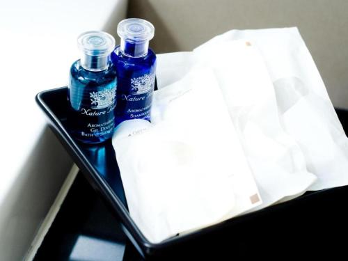 two bottles of water and a bag in a tray at Pannapat Place in Bangkok