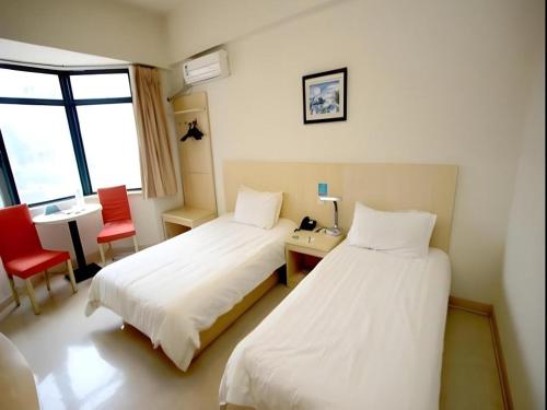 a hotel room with two beds and a desk and chair at JinJiang Inn Nanjing The Confucius Temple Zhonghuamen Metro Station in Nanjing