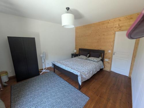 a bedroom with two beds and a wooden wall at Pyrenean Pursuits in Biert