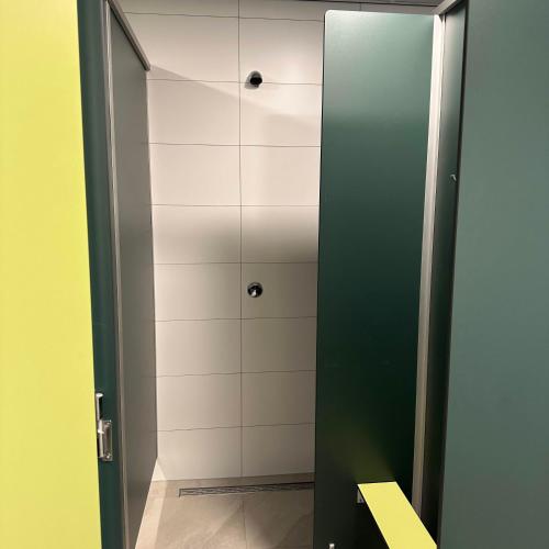 a bathroom with a shower stall with a mirror at Empty camping spot for your tent, caravan and camper in Swalmen