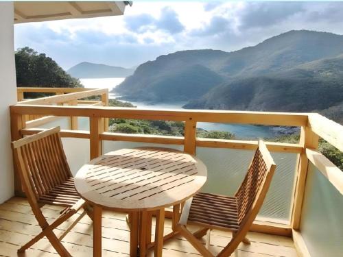 a table and two chairs on a balcony with a view at Hotel Bellreef Otsuki in Otsuki
