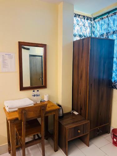 a bathroom with a wooden table and a mirror at MONALISA HOSTEL in Varanasi