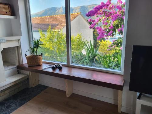 a window with a wooden bench next to a window with flowers at Villa Mila in Korčula Town in Korčula