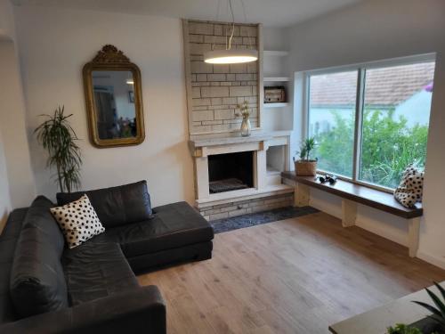 a living room with a couch and a fireplace at Villa Mila in Korčula Town in Korčula