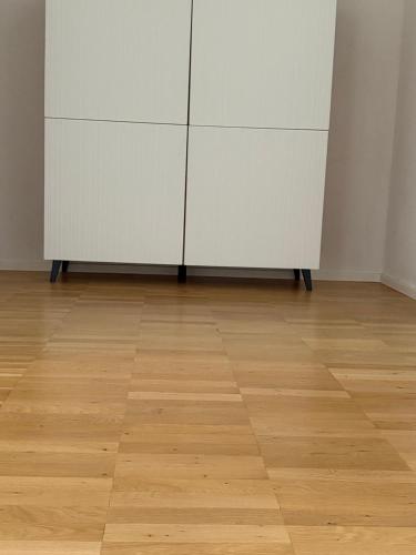 a cabinet in an empty room with a wooden floor at Am Hohentwielblick in Singen