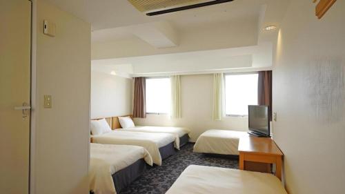 Ένα ή περισσότερα κρεβάτια σε δωμάτιο στο Nansei Kanko Hotel