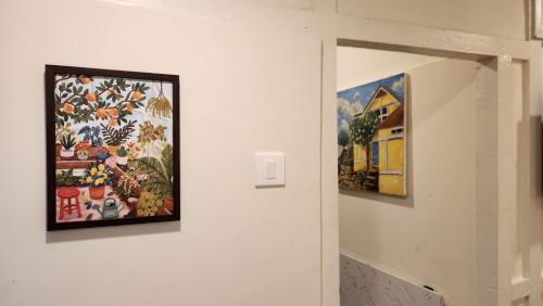a hallway with two paintings on a wall at Rococo by Concordia Hospitality in Shillong