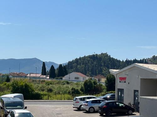 a parking lot with cars parked outside of a gas station at Villa Mandarin in Opuzen