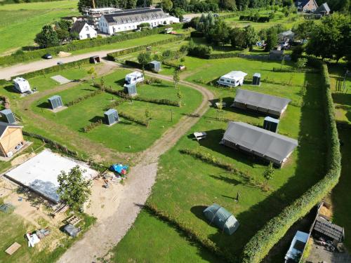 an aerial view of a farm with tents and vehicles at Empty camping spot for your tent, caravan and camper in Swalmen