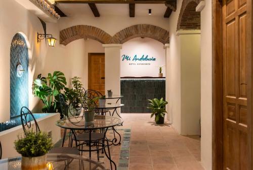 a hallway with tables and chairs in a building at Mi Andalusia Hotel Experience in Málaga