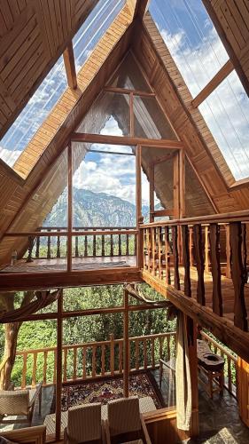 a view from the inside of a cabin with a large window at Applehill Stays - Work & Relax in Kulu