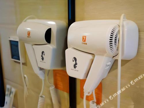 two hair dryers are hanging on a wall at 7 Days Inn Changzhou Yancheng Technology Metro Station in Changzhou