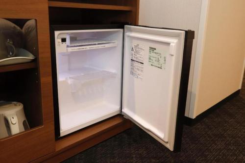 a refrigerator with its door open in a kitchen at KEIKYU EX INN Haneda Innovation City 2 minutes walk from HICity Exit of Tenkubashi Station in Tokyo