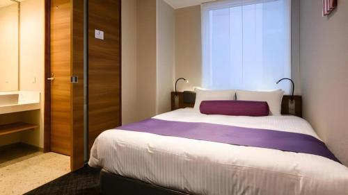a bedroom with a large bed and a window at KEIKYU EX INN Haneda Innovation City 2 minutes walk from HICity Exit of Tenkubashi Station in Tokyo