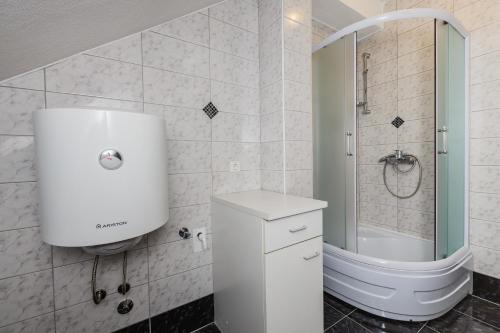 a bathroom with a shower and a toilet and a sink at Apartment Anna in Kaštela