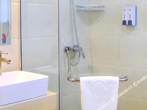 a bathroom with a shower with a toilet and a sink at GreenTree Inn Nanjing Confucius Temple Sanshan Street Subway Station Express Hotel in Nanjing