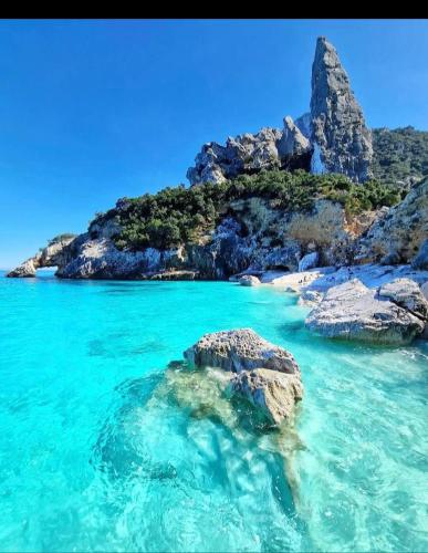 a view of a beach with rocks and blue water at Biginau ' e giosso in Ilbono