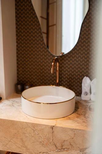 a sink with a faucet on a counter in a bathroom at Qi Yi Nanxu Pavilion Homestay in Kunming