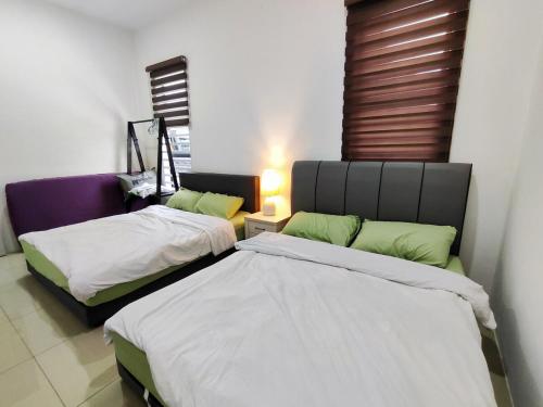 a bedroom with two beds and a window at 2Op Ipoh, Semi D, in Ipoh