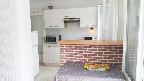 - une cuisine avec un lit au milieu dans l'établissement Les Camellias, à La Baule