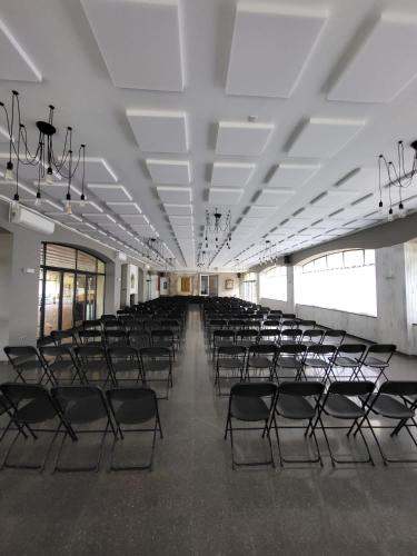 an empty hall with empty chairs in a building at Hostal by El Collell TODO INCLUIDO in Sant Ferriol