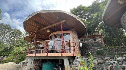 a tree house shaped house with a round roof at LooLa Adventure Resort in Telukbakau