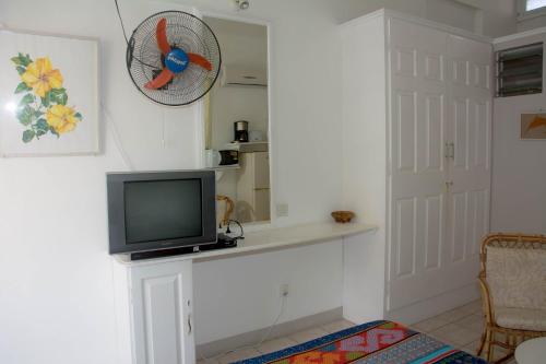 a living room with a tv on a counter at Welcome Holidays in Grand Baie
