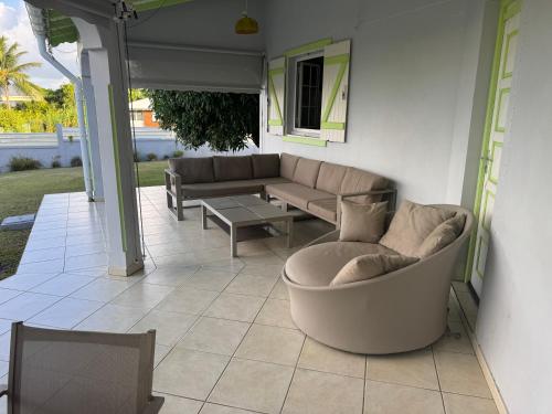 a patio with a couch and a table at Sainval in Îlet à Christophe