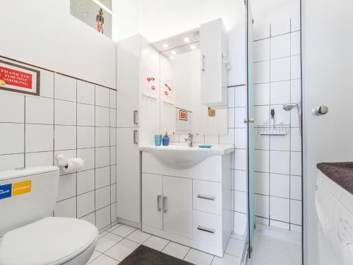 a white bathroom with a toilet and a sink at Central Budapest Vadász Street in Budapest