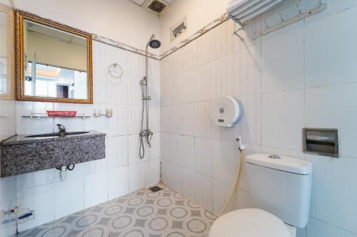 a bathroom with a toilet and a sink at Collection O Eva Hotel District 8 Near Ben Thanh Market in Ho Chi Minh City