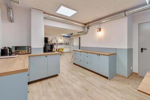 an office with white cabinets and a large room at Apartgdynia in Gdynia