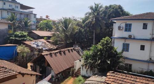 an aerial view of a village with houses and trees at Bagah Beach Hotel in Anjuna