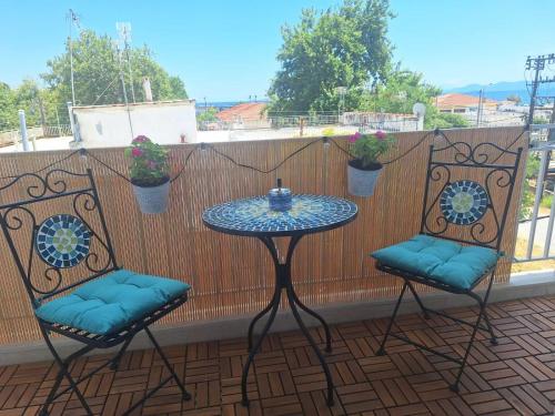 a table and two chairs on a balcony at Sea View Agapi Asprovalta in Asprovalta