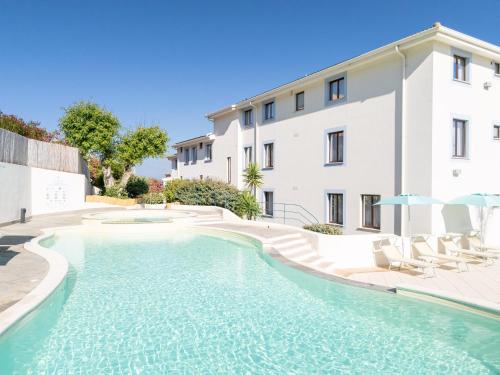 a swimming pool in front of a building at Best Western Hotel Blumarea in Castelsardo