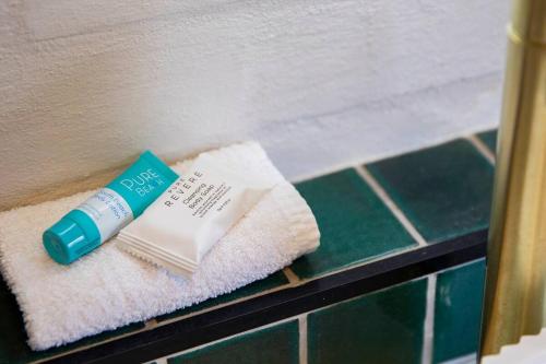 a tube of toothpaste and a book on a towel at The Carrington Cottage 