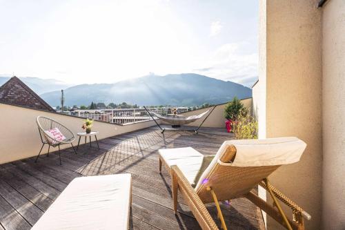a balcony with chairs and a view of a mountain at Superior Sport und Familienresort Alpenblick in Zell am See