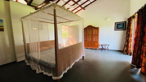 a bedroom with a bed in a clear room at southern grace apartment in Unawatuna