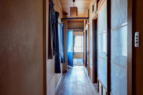 a corridor of a room with a hallway at Denim Lodge Nest in Kurashiki