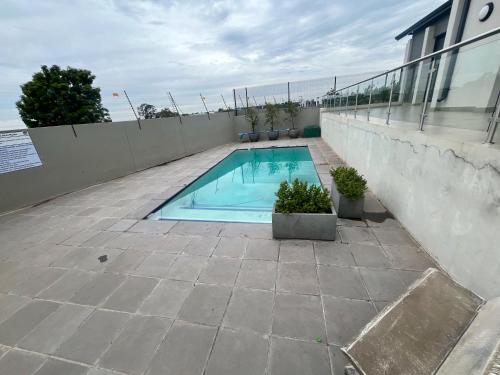 a swimming pool on the side of a building at Casablanca in Midrand