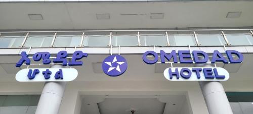 a sign for an emailed hotel on the side of a building at Omedad Hotel in Dirē Kʼalu