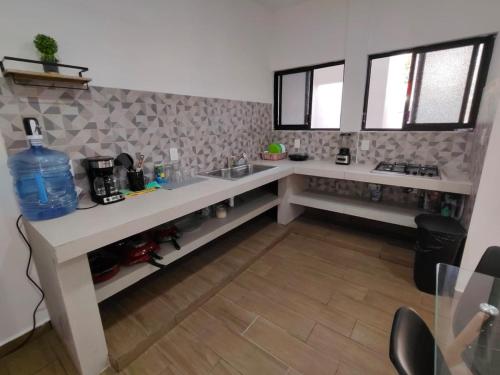 a kitchen with a sink and a counter top at Departamento Grace, moderno y centrico in Campeche