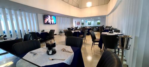 a dining room with tables and chairs in a restaurant at Omedad Hotel in Dirē Kʼalu