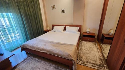 a bedroom with a bed and a window at Eva apartments in Mamaia