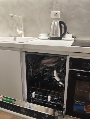 an open oven with a tea kettle on top of it at Grit old Bazaar apartment in Tirane
