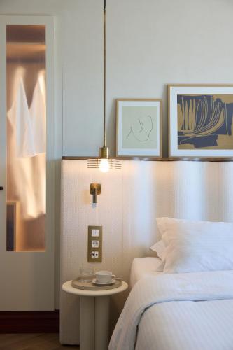 a bedroom with a bed and a table next to a bed at A for Athens in Athens