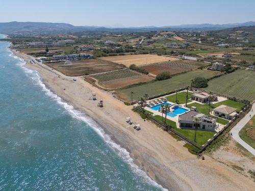 an aerial view of a beach and the ocean at Paralia Beachfront Residence in Georgioupolis