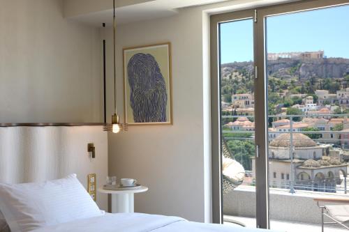 a bedroom with a bed and a large window at A for Athens in Athens
