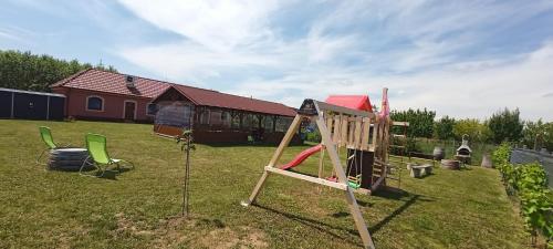 a playground with a slide in a yard at Penzion Sudomír in Sudoměřice